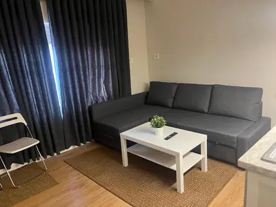 a living room with a couch and a table at Amman Central Cozy Apartment in Amman