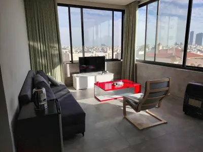 a living room with a couch and a table and a chair at Abu alzoz rooftop 2 in Amman