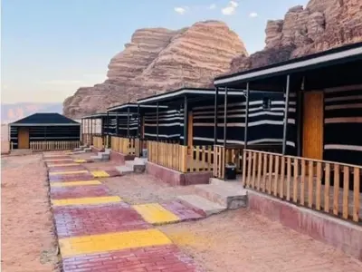 a building in the desert with a mountain in the background at Ayman camp in Wadi Rum