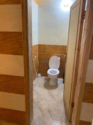 a bathroom with a white toilet in a room at Emad wadi rum camp in Wadi Rum