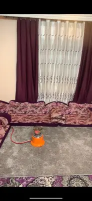 a room with a bed with a curtain and a table at Jordan in Irbid