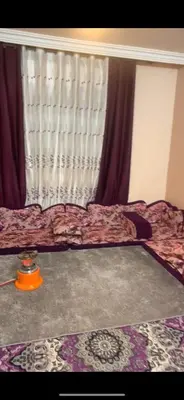 a bedroom with a bed and a window with curtains at Jordan in Irbid