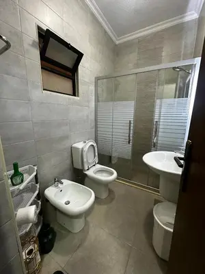 a bathroom with a toilet and a sink at 5-New and Spacious Apartments Close to Market in Rujm ash Sharāʼirah