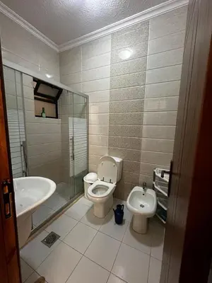 a bathroom with a toilet and a sink at 5-New and Spacious Apartments Close to Market in Rujm ash Sharāʼirah