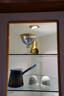 a glass shelf with a bowl and vases on it at Modern Flat in Heart of Amman in Amman