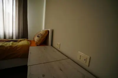 a bedroom with a bed and a wooden table at Modern Flat in Heart of Amman in Amman