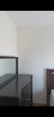 a black dresser with a mirror on top of it at Omar in Al Bunayyāt ash Shamālīyah