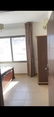 a kitchen with a large window and a tiled floor at Omar in Al Bunayyāt ash Shamālīyah