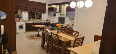 a kitchen with a table and chairs in a kitchen at Luxuries Furnished Apartment in Shmeisani in Amman