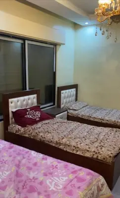 a bedroom with two beds and a chandelier at Omar big house on abdun in Amman