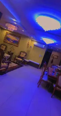 a room with purple lights and a table and chairs at Omar big house on abdun in Amman