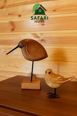 a bird and a small bird statue on a table at اكواخ سفاري السياحية in Ajloun