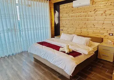 a bedroom with a bed with a teddy bear on it at اكواخ سفاري السياحية in Ajloun