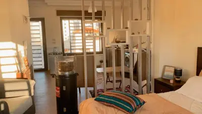 a bedroom with a bed and a couch and a chair at Rooftop View in Amman