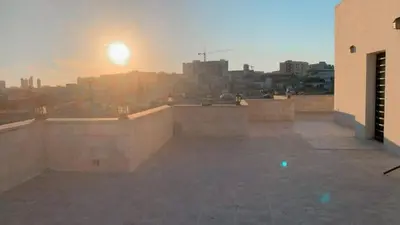 a view of the sunset from the rooftop of a building at Rooftop View in Amman