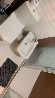 a bathroom with a toilet and a sink at Rooftop View in Amman