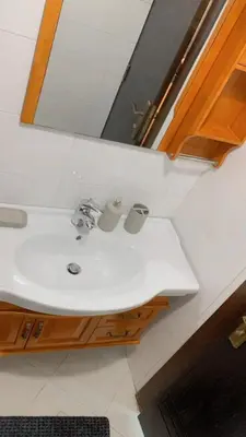 a bathroom with a sink and a mirror at Rooftop View in Amman