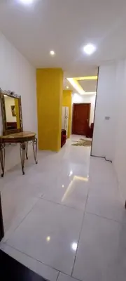 an empty room with a table and a yellow door at amman citadle in Amman