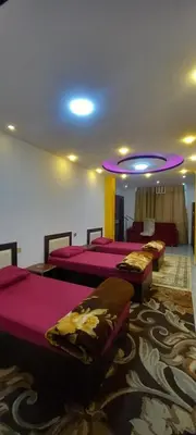a room with four beds and a purple ceiling at amman citadle in Amman