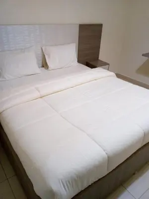 a large white bed in a hotel room at في ظلال الطبيعه in Aqaba