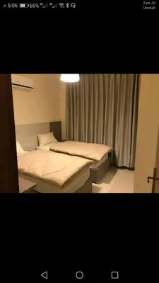 a bedroom with two beds and a window at في ظلال الطبيعه in Aqaba