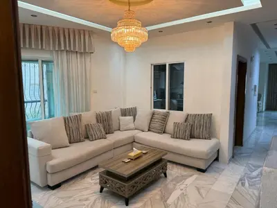 a living room with a couch and a coffee table at Fully Equipped 3BR Apt in Family-Friendly Building in Amman