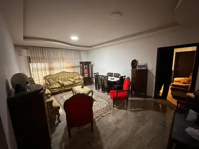 a living room with a couch and chairs and a table at كريستال in Amman