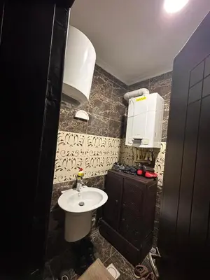 a small bathroom with a sink and a toilet at كريستال in Amman