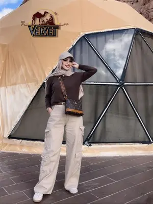 a woman standing in front of a tent at VELVET WADi RUM LUXURY in Wadi Rum