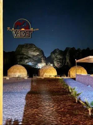 a group of domes at a resort at night at VELVET WADi RUM LUXURY in Wadi Rum