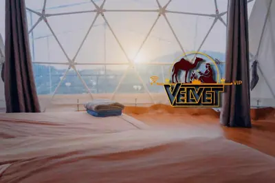 a bedroom with the wnt logo on the wall at VELVET WADi RUM LUXURY in Wadi Rum
