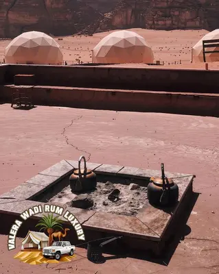 an aerial view of a desert with two pots on a cart at Valera wadi rum Luxury in Wadi Rum