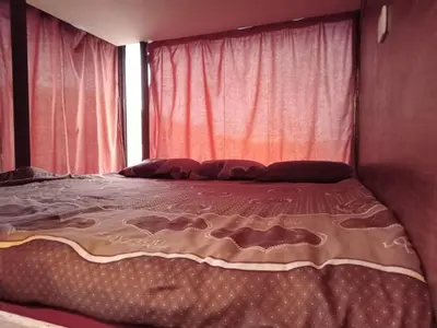a large bed in a room with a window at bedouin hostel in Amman