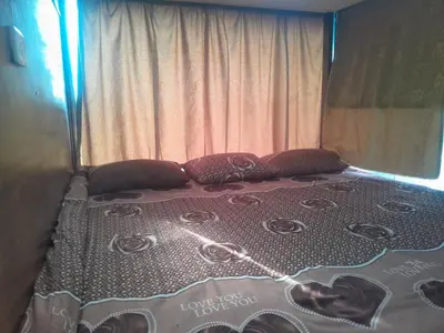 a bed with roses on it in a bedroom at bedouin hostel in Amman