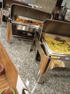 a kitchen with a counter with some food at bedouin hostel in Amman