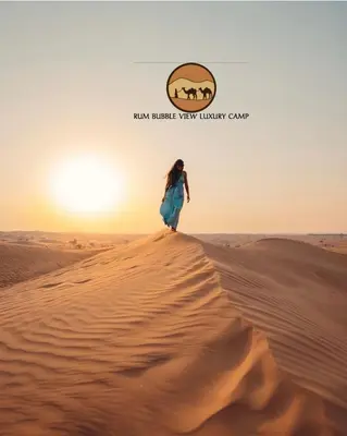 a woman walking on a sand dune in the desert at RUM BUBBLES VIEW lUXURY CAMP in Wadi Rum