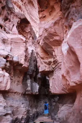 a person standing in front of a canyon wall at Desert Magic Camp in Wadi Rum