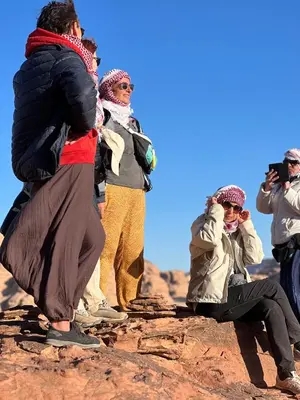 a group of people standing on top of a rock at wadi Rum Spirit of Peace Camp in Wadi Rum