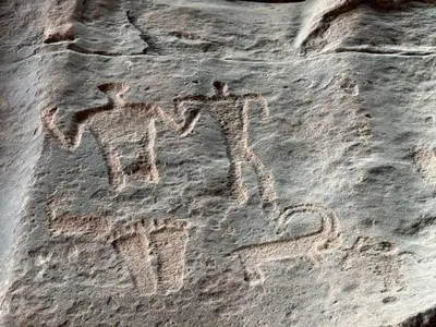 two people painted on the side of a rock at wadi Rum Spirit of Peace Camp in Wadi Rum