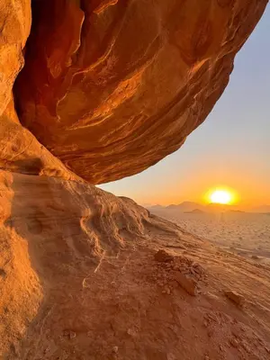 a view of the sunset from a cave in the desert at wadi Rum Spirit of Peace Camp in Wadi Rum
