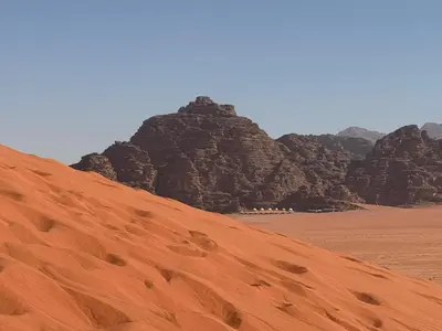 a view of a desert with mountains in the background at wadi Rum Spirit of Peace Camp in Wadi Rum