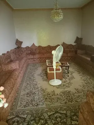 a living room with a couch and a table at Hello hostel in Amman