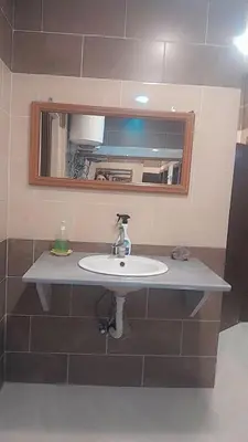 a bathroom with a sink and a mirror at Gorge home in Amman