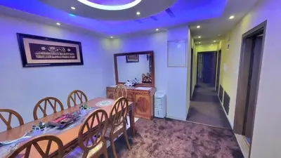 a dining room with a table and chairs at water house in Al Quwaysimah