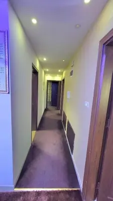 an empty hallway in a building with a long corridor at water house in Al Quwaysimah