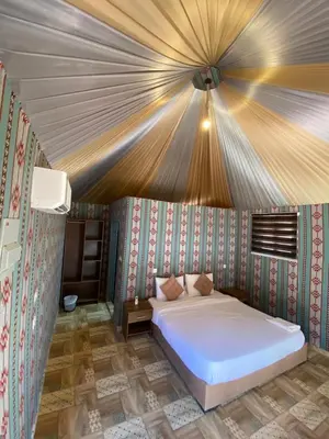 a bedroom with a white bed in a room at wadi Rum Mohammed in Wadi Rum