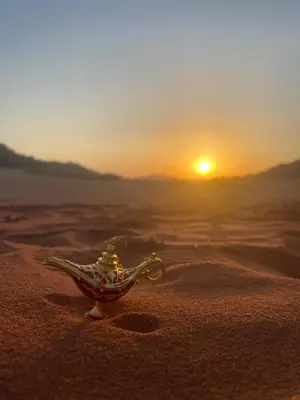 a glass bowl on the beach with the sunset in the background at Wadi Rum Red Desert in Wadi Rum