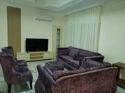 a living room with two couches and a television at Amman Sweet-Home - 2 bedrooms Apartment in Amman