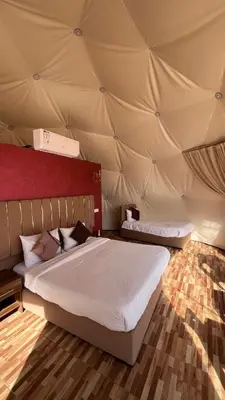 a bedroom with two beds in a tent at Monica Wadi Rum in Wadi Rum
