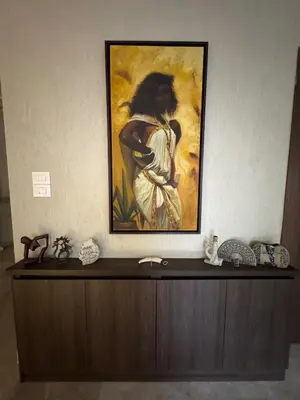 a painting of a woman holding a baby on a wall at Bargos Cave in Amman